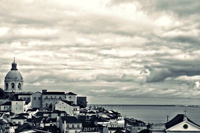 Townscape by sea against sky in city