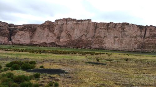 Rock formations on landscape against sky