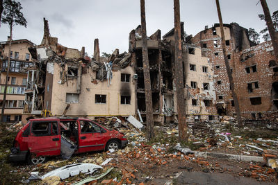 Cities of ukraine after the russian occupation. destroyed buildings on the streets of irpen.