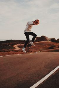 Full length of young woman jumping