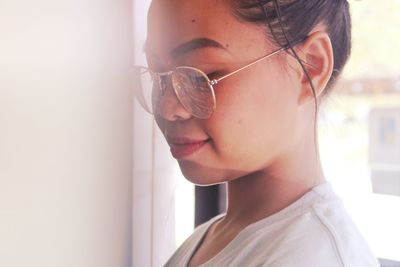 Close-up of young woman wearing eyeglasses at home