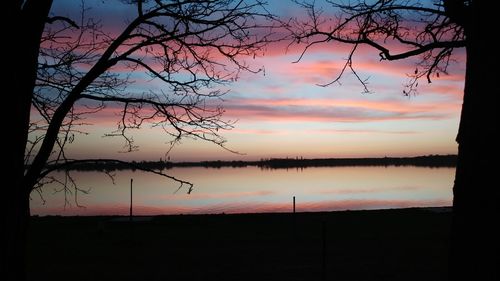 Scenic view of lake against orange sky