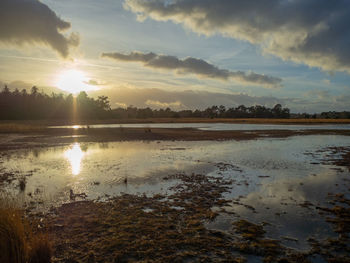 Scenic view of lake against sky during sunset