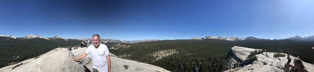 Scenic view of mountains against blue sky