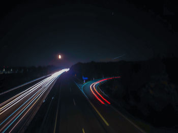 High angle view of light trails on road at night