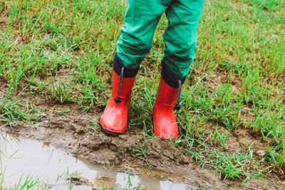 Low section of man standing on mud