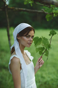 Young woman holding plant