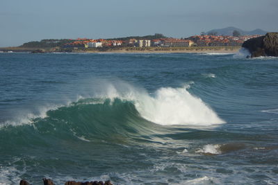 Scenic view of sea against buildings