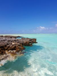 Scenic view of sea against blue sky