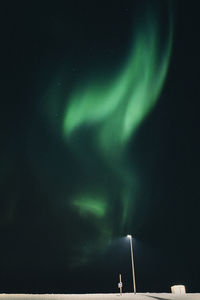 Low angle view of illuminated lights against sky at night