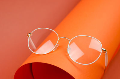 Close-up of sunglasses on yellow background