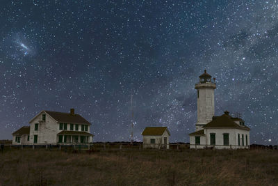 Low angle view of buildings against sky at night