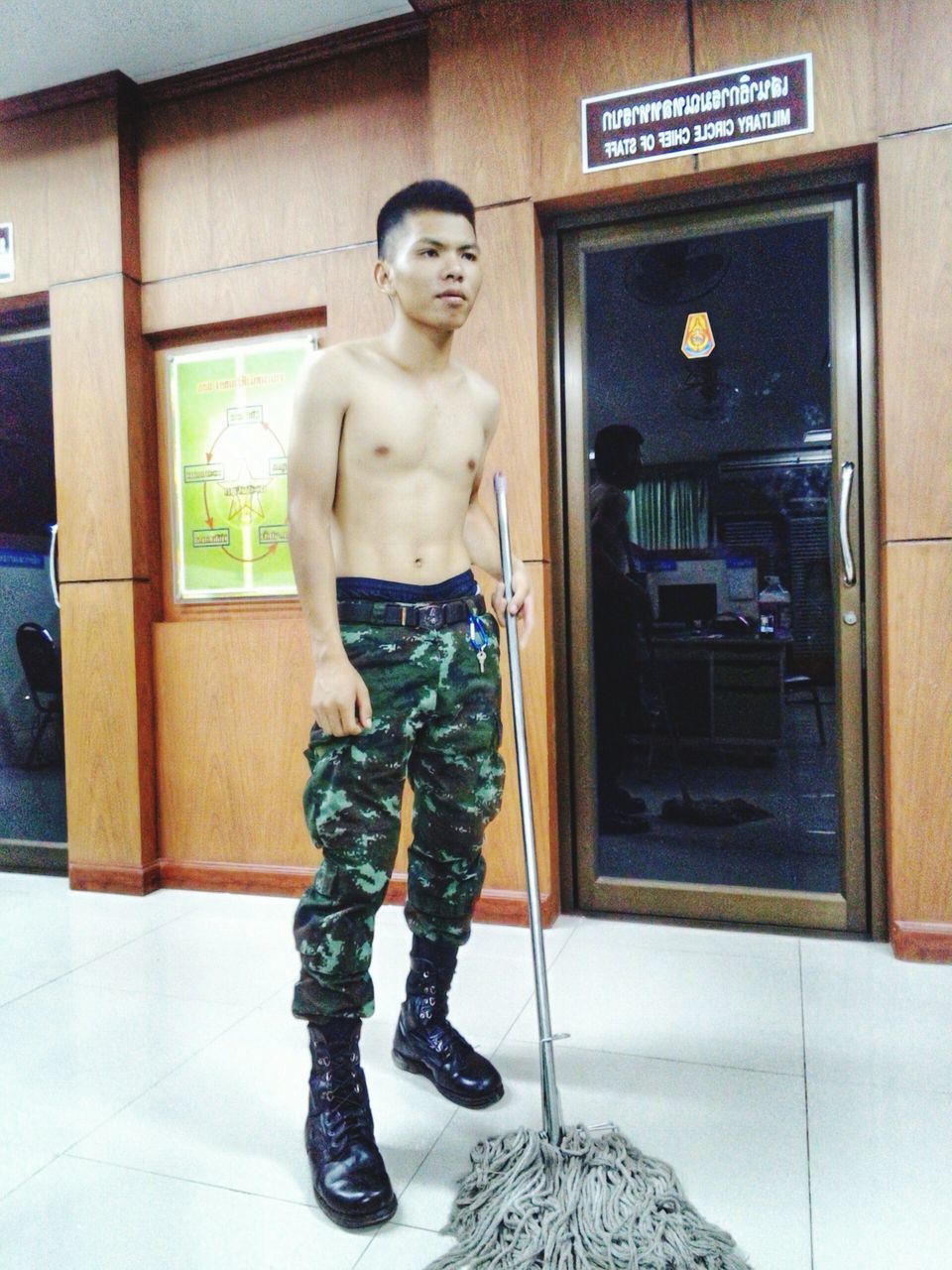 PORTRAIT OF YOUNG MAN STANDING IN ROOM