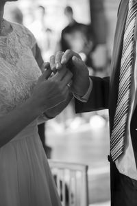 Midsection of couple holding hands