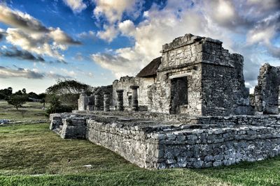 Old ruins on field against sky
