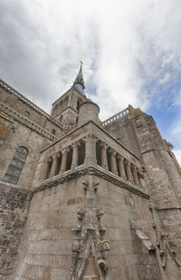 Low angle view of cathedral against cloudy sky