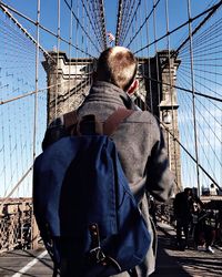 Rear view of man standing at brooklyn bridge
