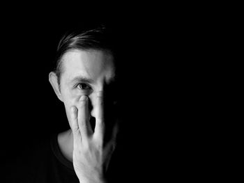 Portrait of man against black background