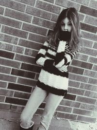 Young woman standing on tiled floor