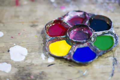 High angle view of colorful water paints in palette on table