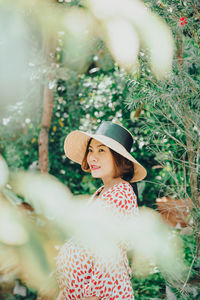 Side view of young woman wearing hat