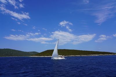 Sailboat sailing on sea against sky