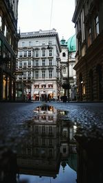 Reflection of buildings in puddle