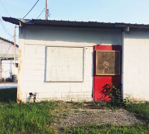 Exterior of house on field against sky