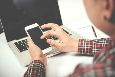 Midsection of man using mobile phone