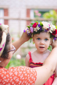 Portrait of cute girl with pink flowers