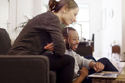 Happy illustrators using laptop in creative office