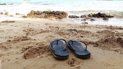 High angle view of shoes on beach