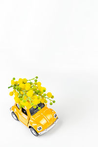 Close-up of yellow toy car against white background