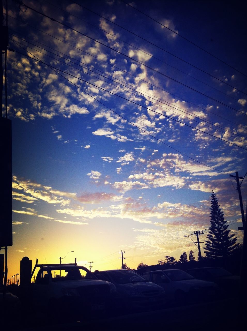 silhouette, sky, sunset, transportation, cloud - sky, low angle view, car, power line, dusk, cloud, mode of transport, street light, building exterior, built structure, nature, land vehicle, dark, outdoors, no people, beauty in nature