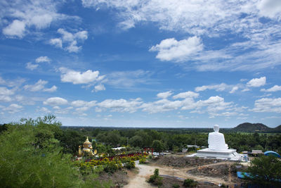 View of temple on building against cloudy sky