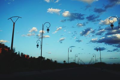 Road amidst trees against sky