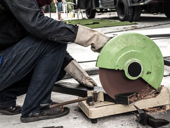 Low section of man working on metal structure