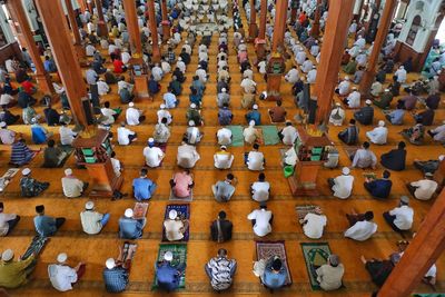 High angle view of people sitting on table