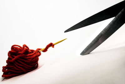 Close-up of colored pencils over white background