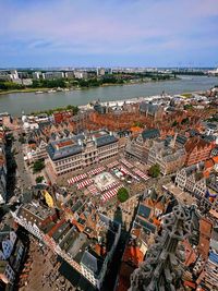 High angle view of townscape by sea against sky