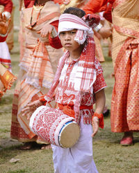 Rear view of child standing in traditional clothing