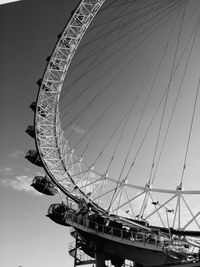 Low angle view of ferris wheel against sky