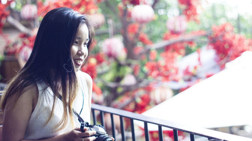 Portrait of young woman looking away outdoors