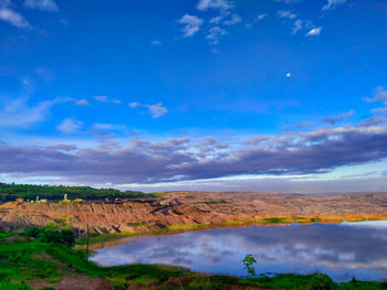 Scenic view of landscape against blue sky