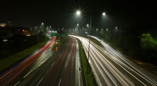 High angle view of light trails on road at night