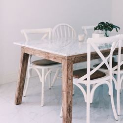 Close-up of white chairs and table