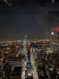 High angle view of illuminated buildings in city at night