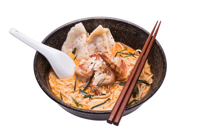 High angle view of food in bowl against white background