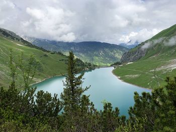 Scenic view of lake and mountains against sky