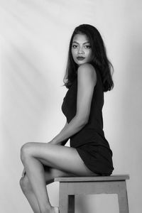 Portrait of a young woman sitting outdoors